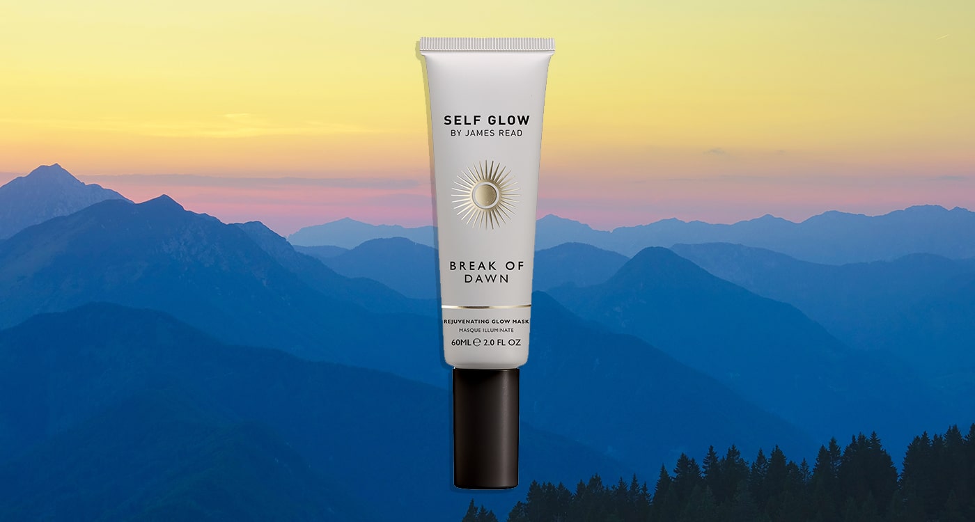 James Read's Self Glow Break of Dawn 20 Minute Glow Mask in sustainable, recycled plastic packaging, cropped over a landscape image of mountains at golden hour, showcasing the brand's commitment to eco-friendly materials.