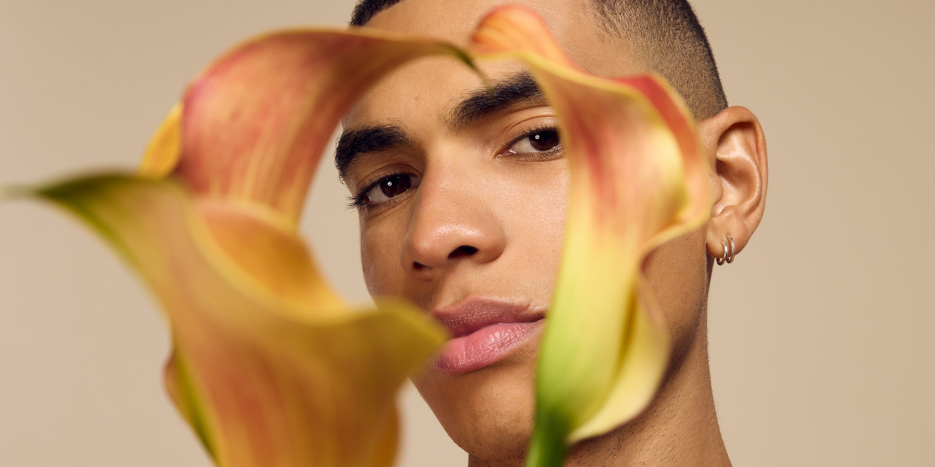 Self Glow by James Read: A sunless tanning product for a natural glow that transcends all seasons, featuring a model's face surrounded by floral tulips.