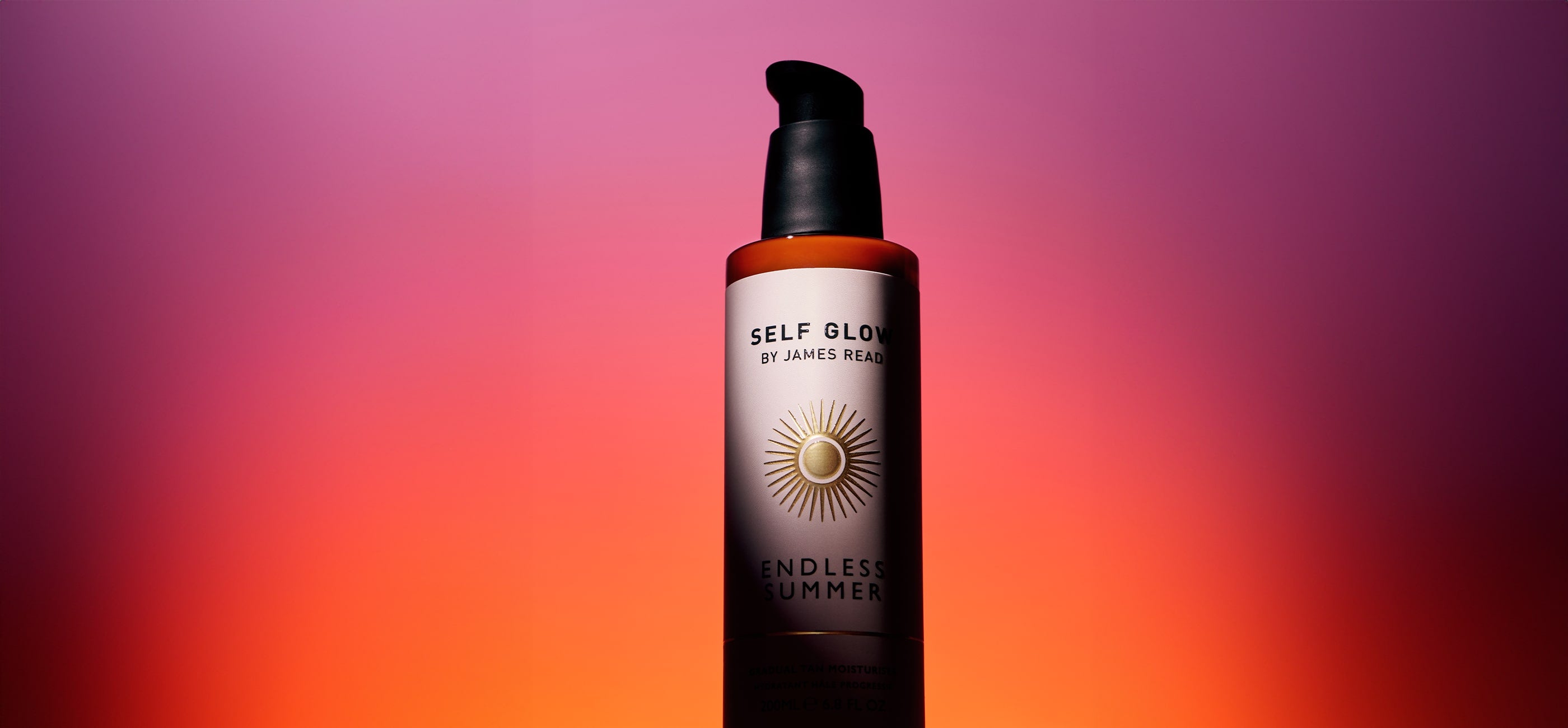 Self Glow by James Read Endless Summer Gradual Tan Moisturiser bottle in warm golden light with soft sunlit shadows, used as homepage hero image.