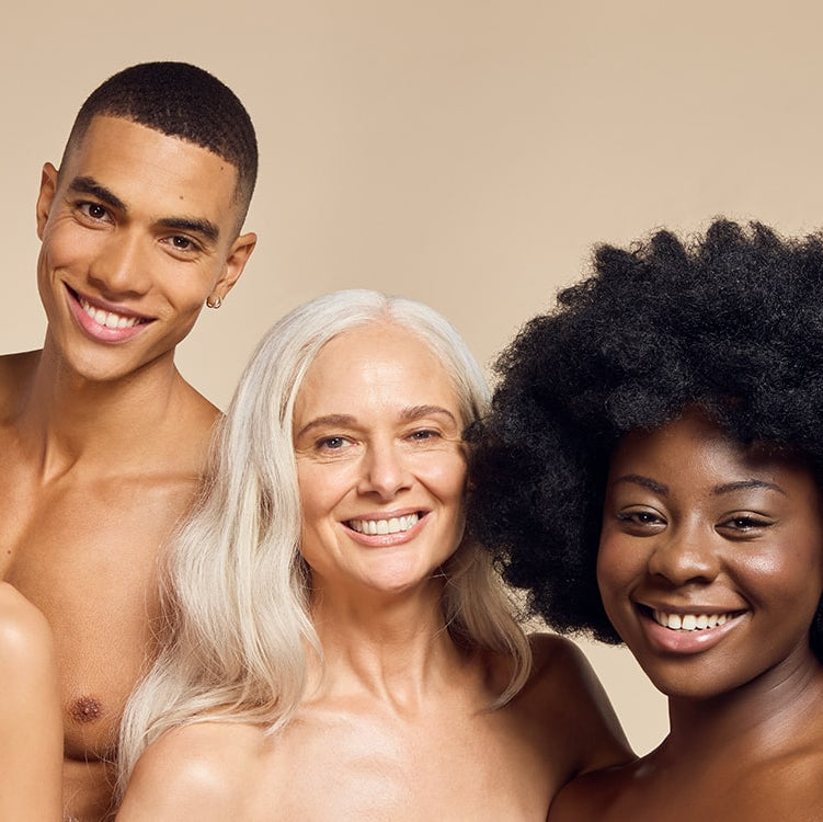 A diverse group of models with various skin types and tones smiling and showing off their radiant, glowing skin achieved with James Read's Self Glow fake tan products.